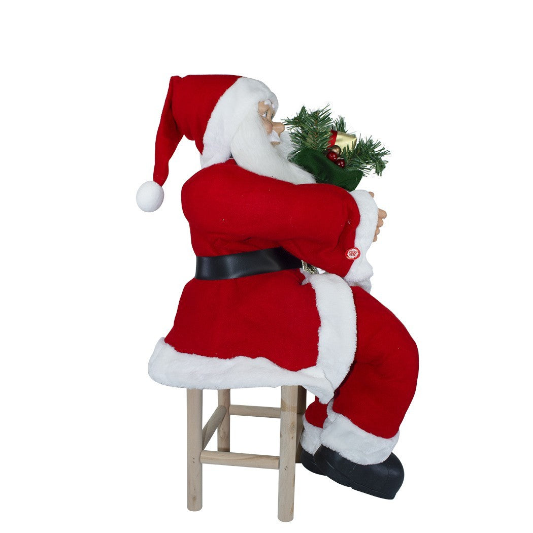Père Noël assis sur la chaise 90cm 144059 avec sac cadeaux et sons de décoration