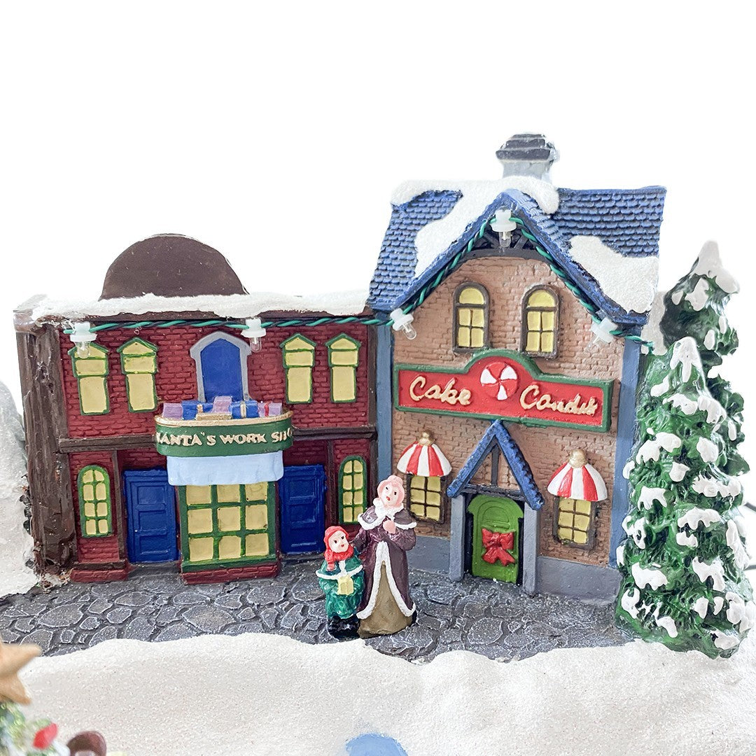 Village de Noel enneigé Carrousel Lumières Sons Mouvement 37x21x27cm